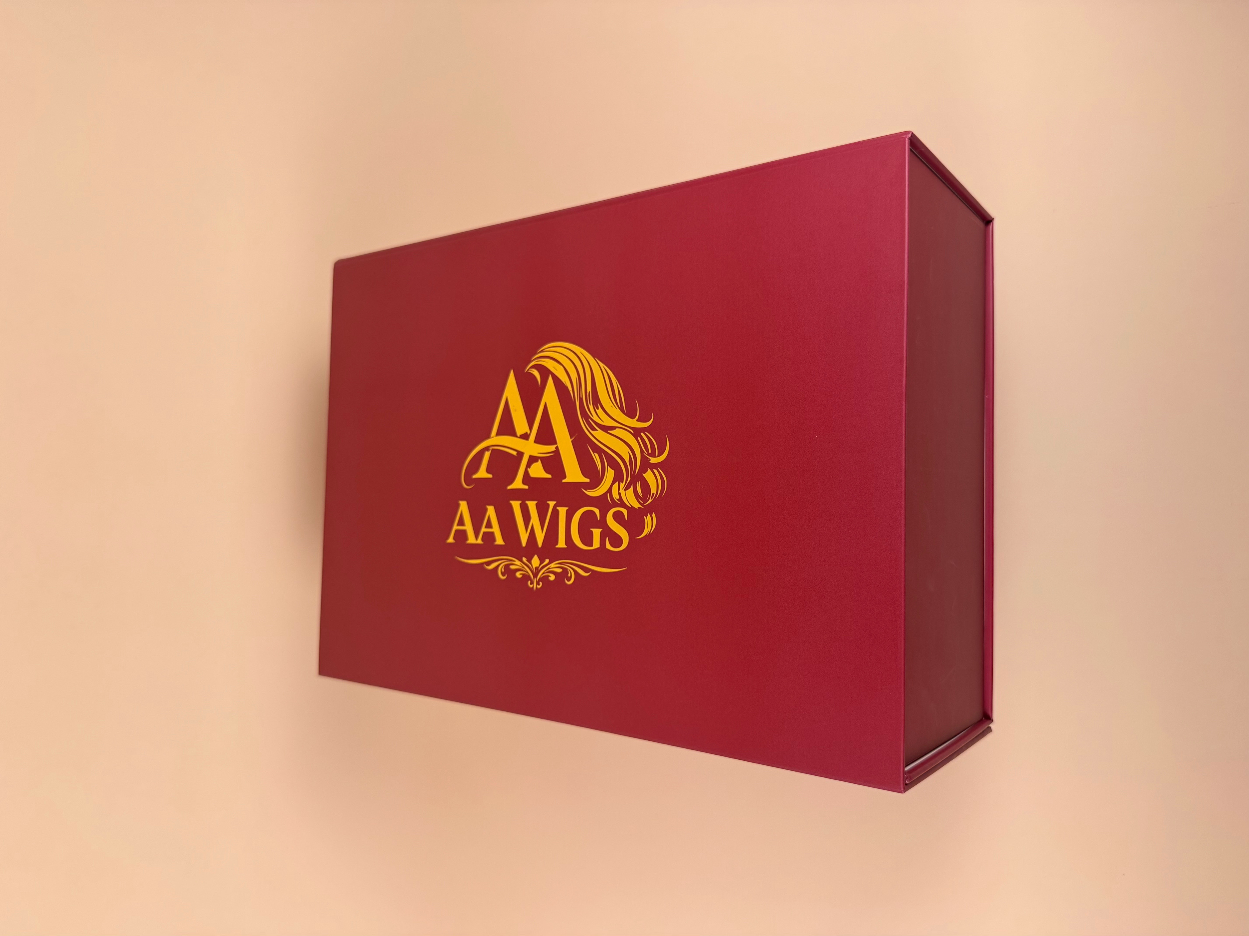 AA WIGS deep burgundy signature box with gold foil logo — the luxury unboxing experience